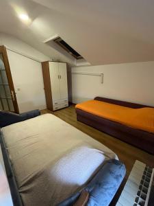 a small room with two beds and a cabinet at Apartman D&D in Vukovar