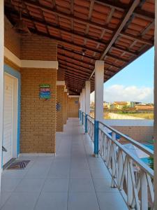 a walkway on a building with a wooden ceiling at Torre do Sol in Praia do Frances