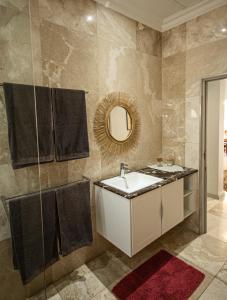 a bathroom with a sink and a mirror at Walter’s Place in Jongensfontein