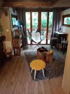 a living room with a table and a chair at Micro maison ISBA Sedan in Givonne