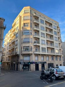 a yellow building with a motorcycle parked in front of it at Coeur de Marseille in Marseille