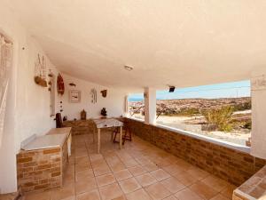 a room with a table and a view of the beach at Guest House Calalunga Scogliera in Carloforte