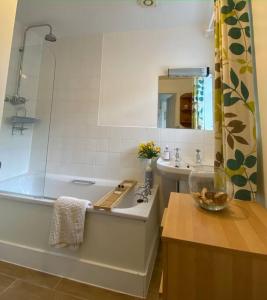 a bathroom with a tub and a sink and a bowl at Castle Kennels in Aberfeldy