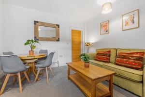 a living room with a couch and a table at Ground Floor Apartment with Courtyard in Loughborough