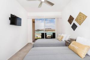 a bedroom with two beds and a view of the ocean at Eagle Village at Islas del Mar C7 in Puerto Peñasco