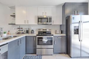 a kitchen with white cabinets and stainless steel appliances at Eagle Village at Islas del Mar C7 in Puerto Peñasco