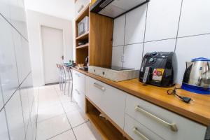 a kitchen with a counter top with a appliance on it at 20%OFF até 4hospedes Wi-fi 400Mb/s ,Cozinha Compl in Brasilia