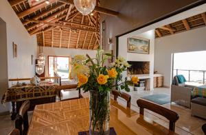 a living room with a vase of flowers on a table at Walter’s Place in Jongensfontein