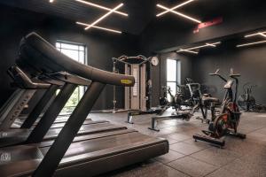 a gym with several treadmills and exercise bikes at Midlands Park Hotel in Portlaoise
