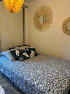 a bedroom with a bed with pillows on it at Fos Plage - Studio in Fos-sur-Mer