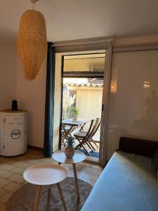 a living room with a couch and a table at Fos Plage - Studio in Fos-sur-Mer