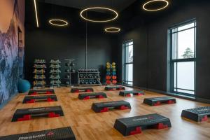 a gym with yoga mats in a room with windows at Midlands Park Hotel in Portlaoise