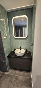 a bathroom with a sink and a mirror at Infinity sea view in Lavrio
