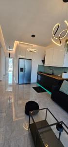 a living room with a couch and a table at Infinity sea view in Lavrio +6 photos