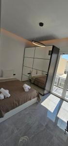 a bedroom with a bed and a large window at Infinity sea view in Lavrio