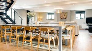 a kitchen and dining room with a table and chairs at The Telephone Exchange at Parsley Hay in Buxton +4 photos