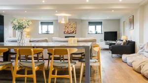 a dining room and living room with a table and chairs at The Telephone Exchange at Parsley Hay in Buxton