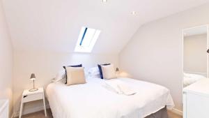 a bedroom with a white bed and a window at The Telephone Exchange at Parsley Hay in Buxton