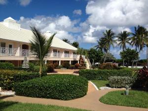 a house with a walkway in front of a building at GetAways at Dover House Resort in Delray Beach