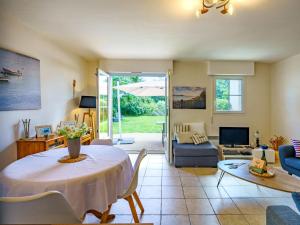 a living room with a table and a couch at Holiday Home La Marinière Izella - SNR101 by Interhome in Sainte-Marine