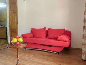 a red couch in a living room with a table at Apartment Alba by Interhome in Zermatt