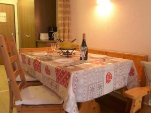 una mesa con una botella de vino y copas. en Apartment Pasadena by Interhome, en Zermatt