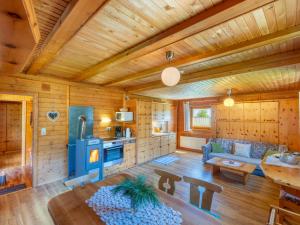 a living room with a blue stove in a cabin at Holiday Home Weissmann by Interhome in Mayerling