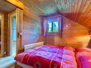 a bedroom with a bed in a wooden room at Holiday Home Weissmann by Interhome in Mayerling