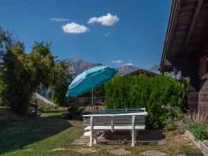 ナンダにあるChalet Lao-Lao by Interhomeの庭の青傘付きベンチ