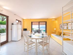 a kitchen and dining room with a table and chairs at Apartment Turistica-1 by Interhome in Capoliveri