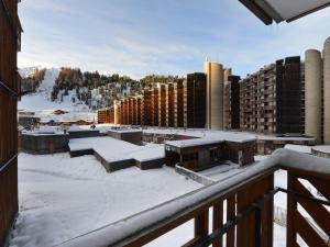 a view from the balcony of a building in the snow at Studio chaleureux avec balcon, piscine et proche pistes - FR-1-181-2132 in La Plagne Tarentaise +3 photos