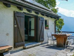 a building with a door and a table and chairs at Holiday Home Rustico Girasole by Interhome in Leontica