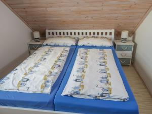 two beds in a room with two night stands at Holiday Home Achterblick 2 by Interhome in Altefähr