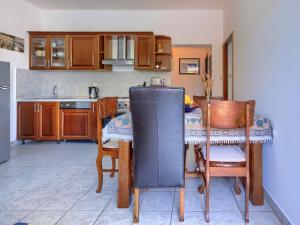 a kitchen with a table and chairs and a refrigerator at Apartment Gabi - MDN168 by Interhome in Ližnjan