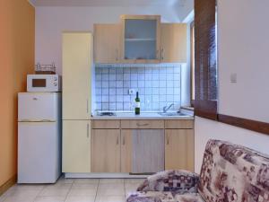 a kitchen with a white refrigerator and a sink at Apartment Gabi - MDN152 by Interhome in Ližnjan