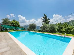 uma piscina com água azul e montanhas ao fundo em Holiday Home Podere Piastriccio by Interhome em Medicina