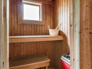 a wooden cabin with a bench and a window at Chalet Högvallen Elden - JAM025 by Interhome in Undersåker