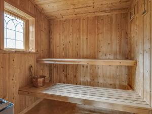a wooden sauna with a bench in a room at Chalet Korpstigen Älgen - DAN075 by Interhome in Sälen