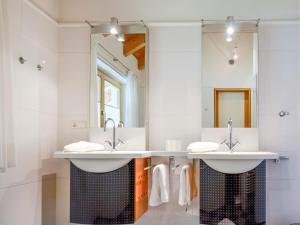 a bathroom with two sinks and a large mirror at Apartment Kathrein - ISL507 by Interhome in Ischgl