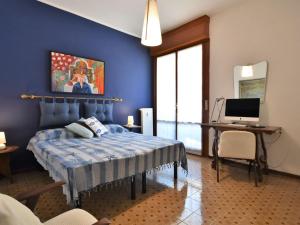 a bedroom with a bed and a desk with a computer at Apartment Park Apartment by Interhome in Rapallo