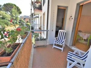 a balcony with two chairs and flowers on a building at Apartment Park Apartment by Interhome in Rapallo