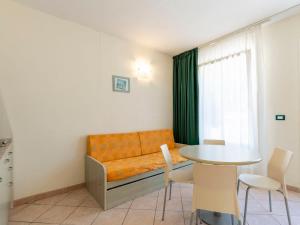 een woonkamer met een bank en een tafel bij Apartment Borgoverde-4 by Interhome in Imperia