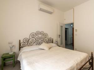 - une chambre avec un grand lit blanc et une grande tête de lit dans l'établissement Apartment Sant'Antonio by Interhome, à Alassio