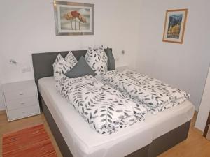 - un lit avec des oreillers en noir et blanc dans l'établissement Apartment Walzthöni by Interhome, à Wenns