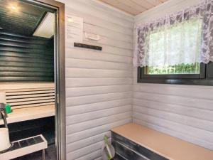 a small room with a window in a tiny house at Holiday Home Eteläaho by Interhome in Nykälä