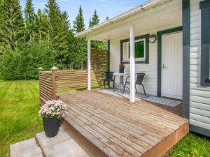a wooden deck on the side of a house at Holiday Home Eteläaho by Interhome in Nykälä