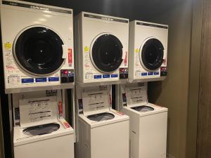 a group of washers and dryers in a room at APA Hotel & Resort Nishishinjuku-Gochome-Eki Tower in Tokyo