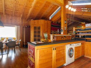 a kitchen with a washing machine and a dining room at Chalet Mayens by Interhome in Agettes