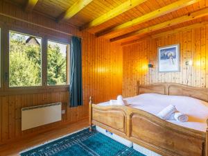 a bedroom with a bed in a wooden room at Chalet Mayens by Interhome in Agettes
