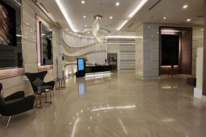 a lobby with chairs and a television in a building at Condo with Balcony at Makati SM Jazz in Manila